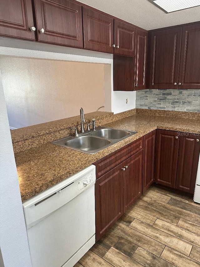 kitchen featuring white dishwasher, sink, backsplash, and dark hardwood / wood-style flooring