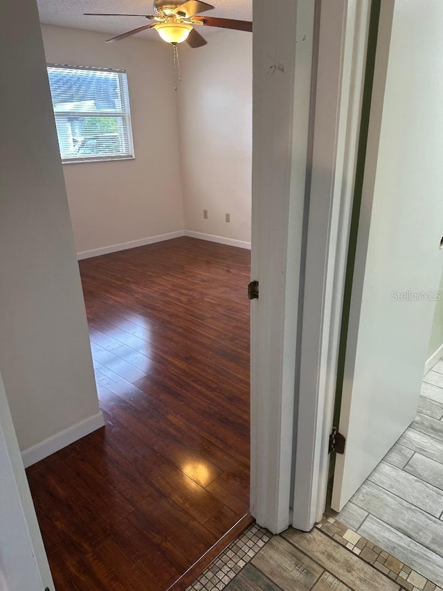 unfurnished room featuring hardwood / wood-style floors and ceiling fan