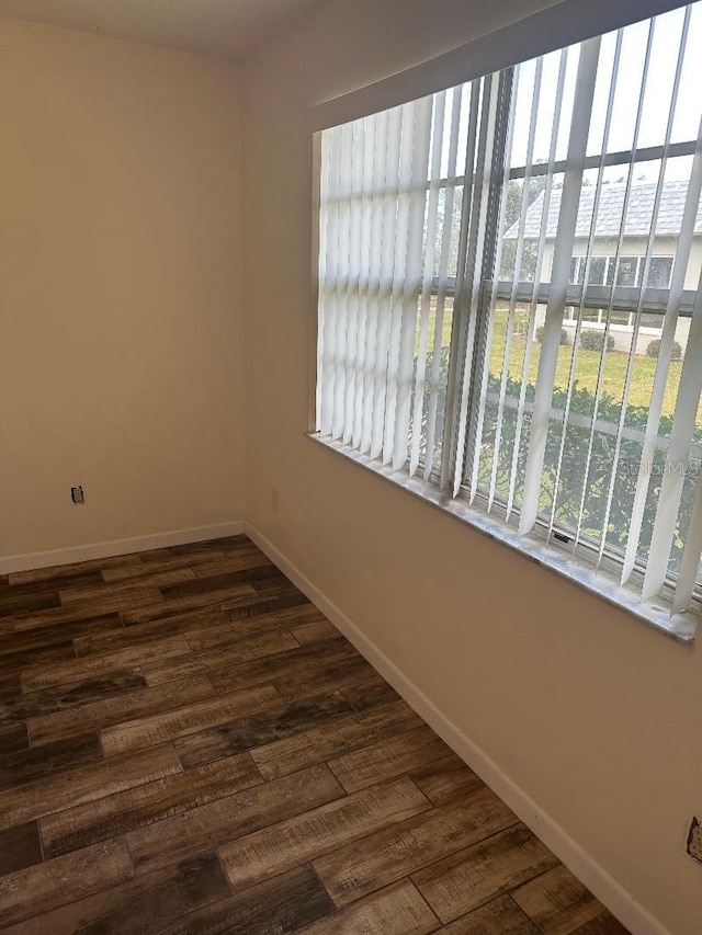 unfurnished room with dark hardwood / wood-style floors