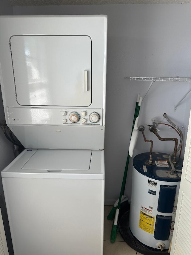 laundry area with stacked washer / dryer and electric water heater