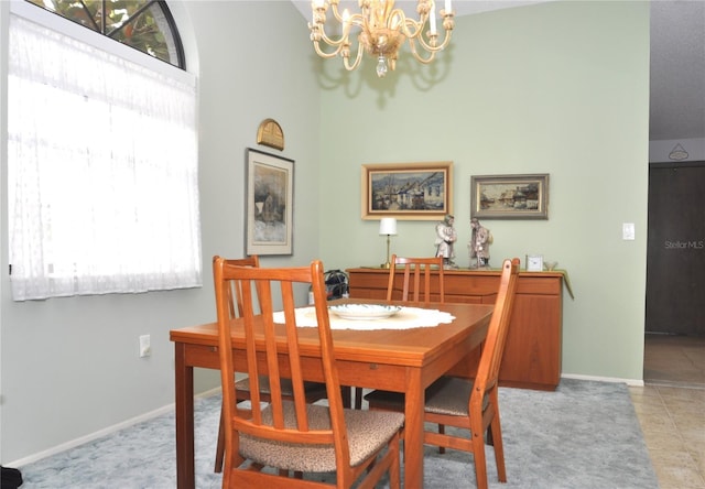 dining room featuring light tile patterned floors and a notable chandelier