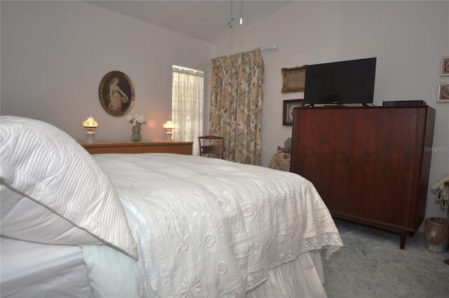 carpeted bedroom featuring vaulted ceiling