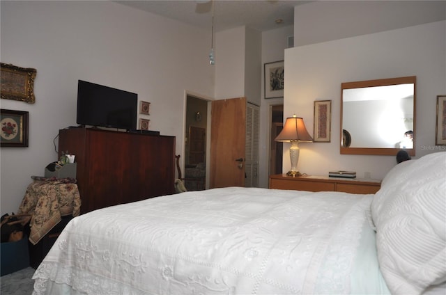 bedroom featuring a closet and a high ceiling