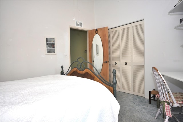 bedroom featuring carpet floors, a closet, and a high ceiling