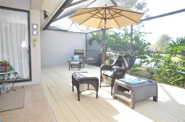 wooden deck featuring glass enclosure