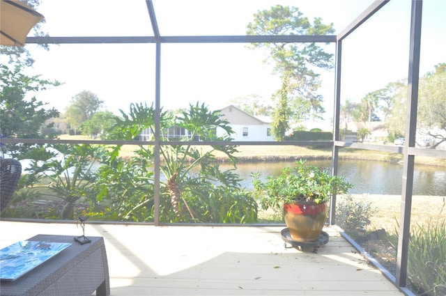 sunroom with plenty of natural light and a water view