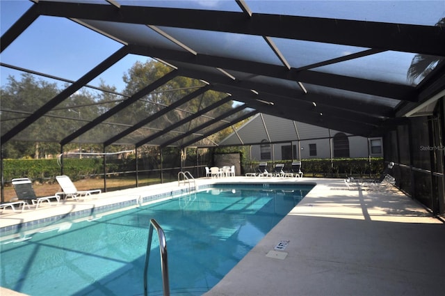 view of swimming pool with a patio and a lanai