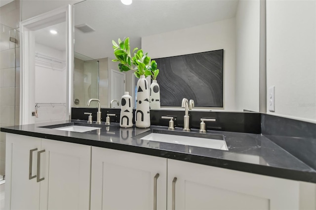 bathroom featuring vanity and decorative backsplash