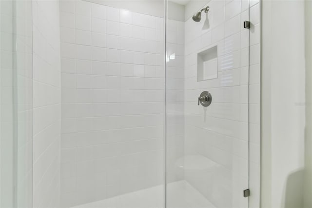 bathroom with a shower with shower door