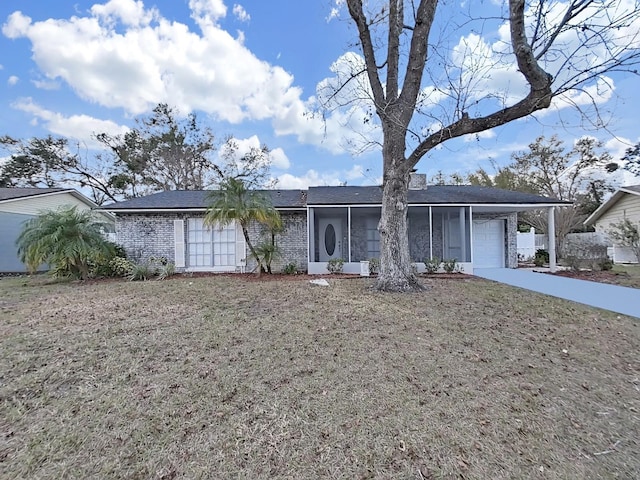 ranch-style home featuring a garage, a front yard, and a carport