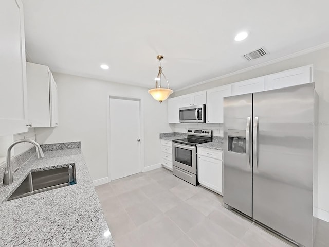 kitchen with white cabinetry, sink, decorative light fixtures, and stainless steel appliances