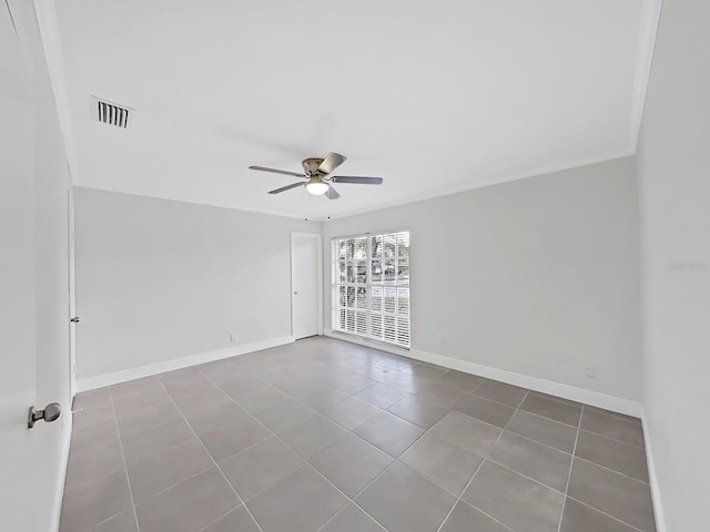 tiled empty room featuring ceiling fan