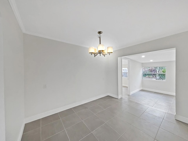 tiled empty room with a chandelier