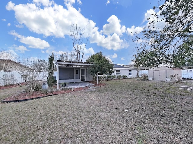 rear view of house with a patio and a lawn