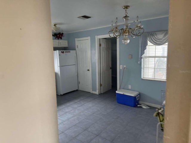 unfurnished dining area featuring ornamental molding and a notable chandelier