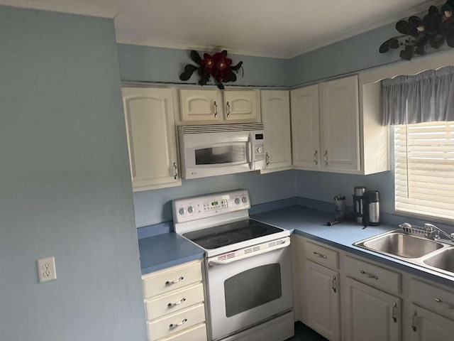 kitchen featuring white cabinetry, sink, and white appliances