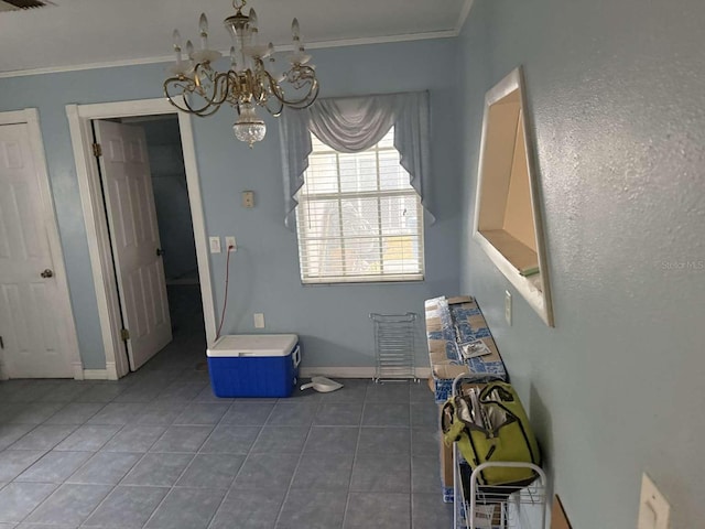 unfurnished dining area with an inviting chandelier, ornamental molding, and dark tile patterned floors