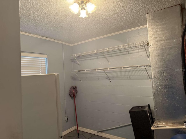 laundry room with crown molding and a textured ceiling