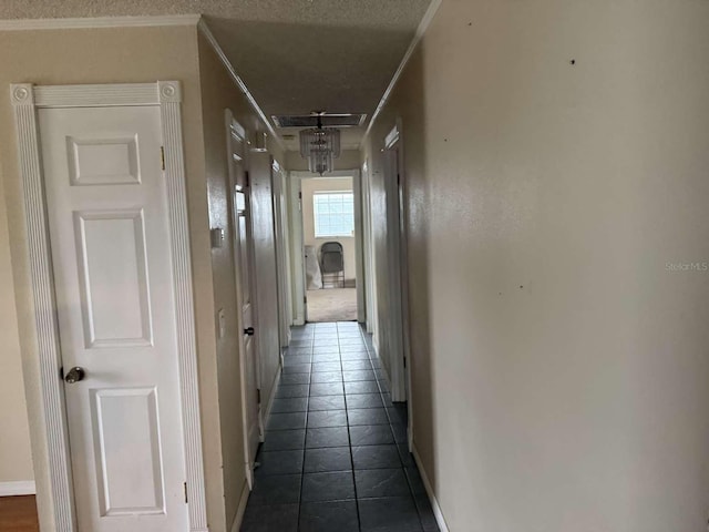 hallway featuring crown molding and a textured ceiling