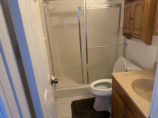 bathroom with vanity, tile patterned floors, toilet, and walk in shower