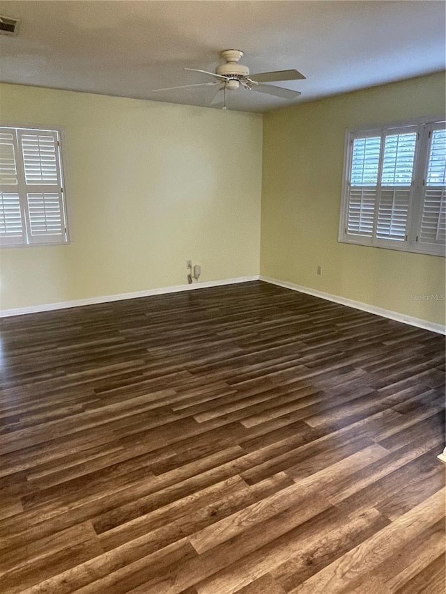 spare room featuring dark hardwood / wood-style flooring and ceiling fan