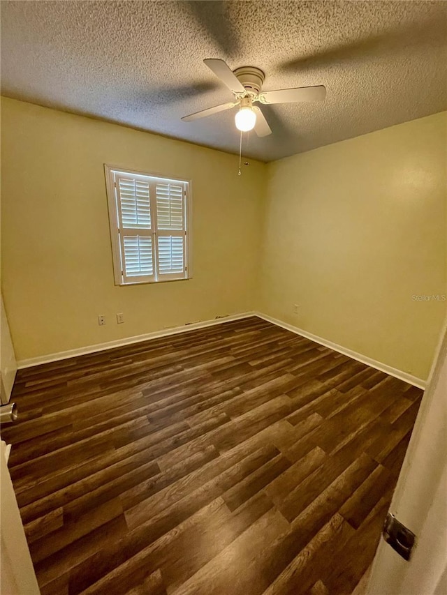 unfurnished room featuring ceiling fan, dark hardwood / wood-style floors, and a textured ceiling