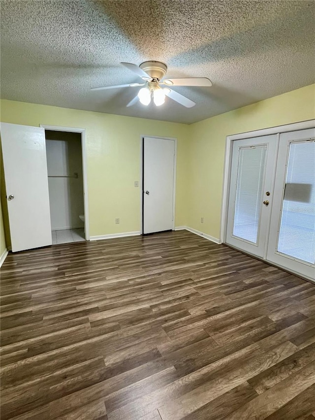 unfurnished bedroom featuring french doors, ceiling fan, dark hardwood / wood-style floors, and a textured ceiling