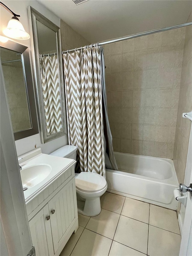 full bathroom with vanity, shower / tub combo, tile patterned floors, and toilet