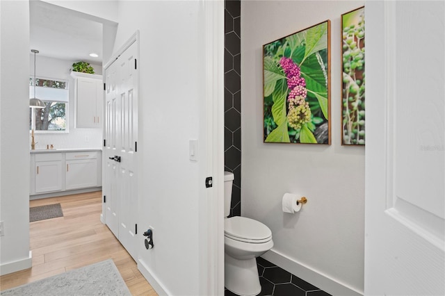 bathroom featuring vanity, hardwood / wood-style floors, and toilet