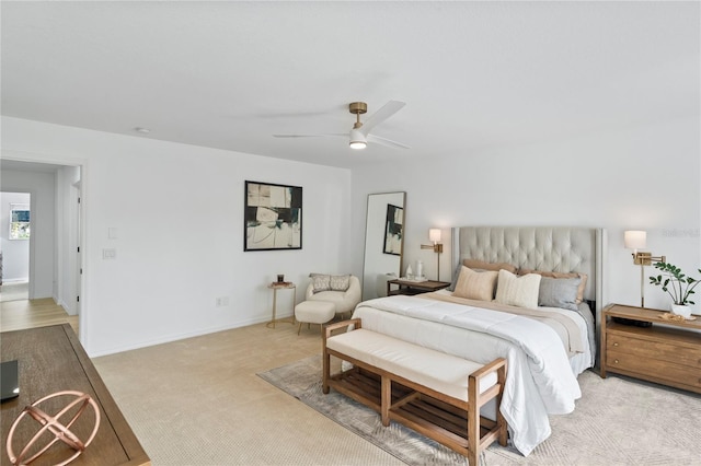 bedroom featuring light colored carpet and ceiling fan