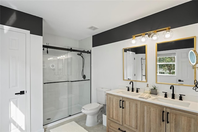 bathroom with walk in shower, vanity, and toilet