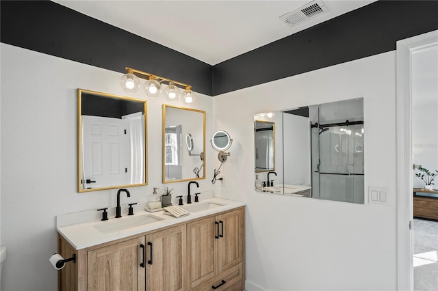 bathroom featuring vanity and a shower with door