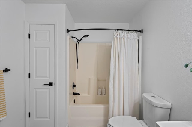 bathroom featuring shower / tub combo and toilet