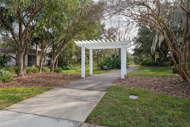 view of community with a pergola and a lawn