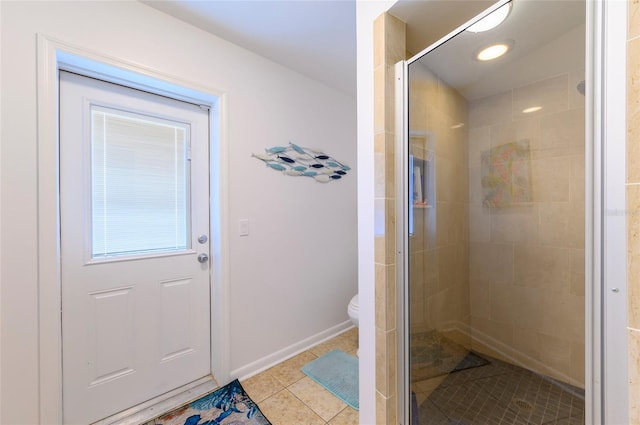 bathroom with tile patterned flooring, a shower with door, and toilet