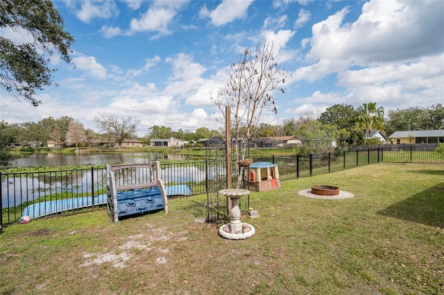 view of yard featuring a water view and an outdoor fire pit