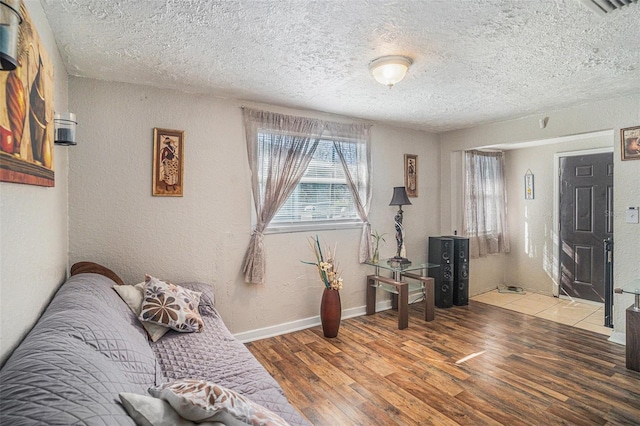 living area featuring hardwood / wood-style floors and a textured ceiling