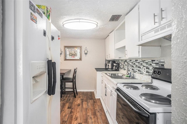 kitchen featuring range with electric stovetop, sink, white cabinets, backsplash, and white refrigerator with ice dispenser