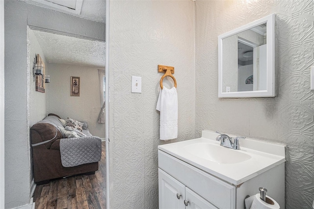 bathroom featuring vanity, wood-type flooring, and a textured ceiling