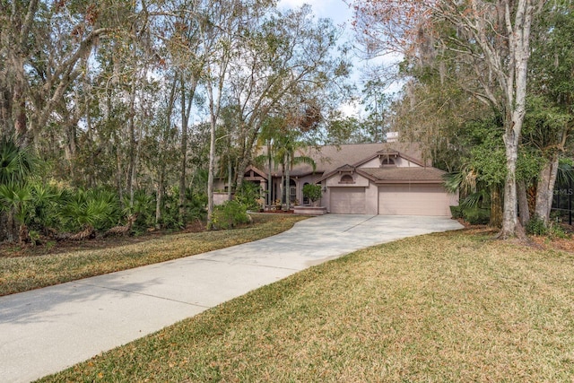 view of front of house with a garage and a front yard