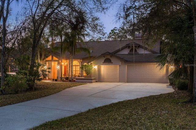 view of front of property featuring a garage and a front yard