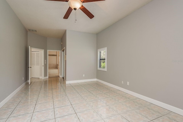 tiled empty room with ceiling fan