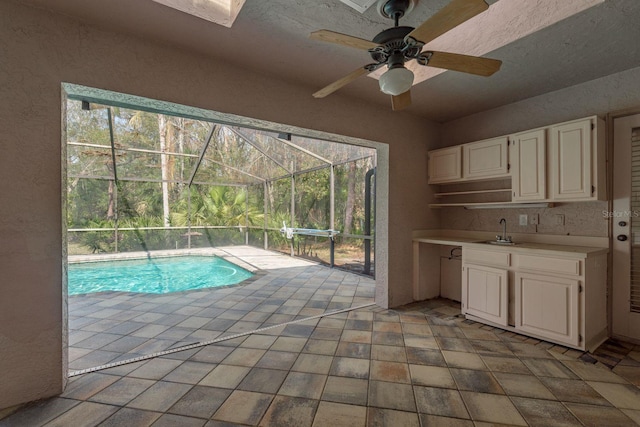 view of swimming pool with sink and ceiling fan