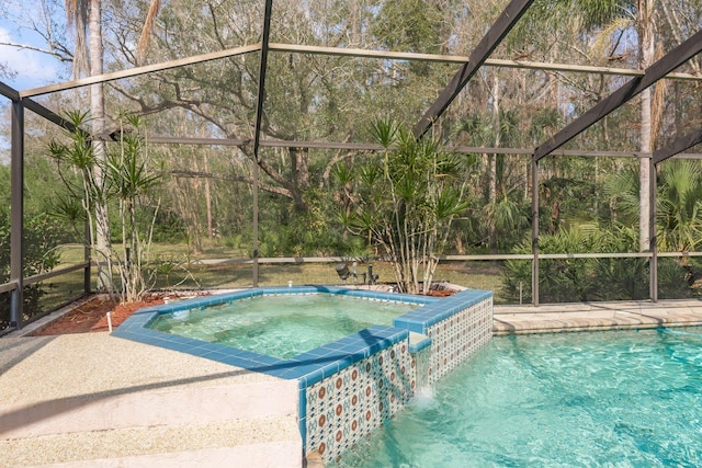 view of swimming pool featuring an in ground hot tub and a lanai