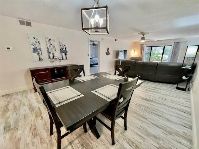 dining room with ceiling fan, light hardwood / wood-style floors, and a textured ceiling