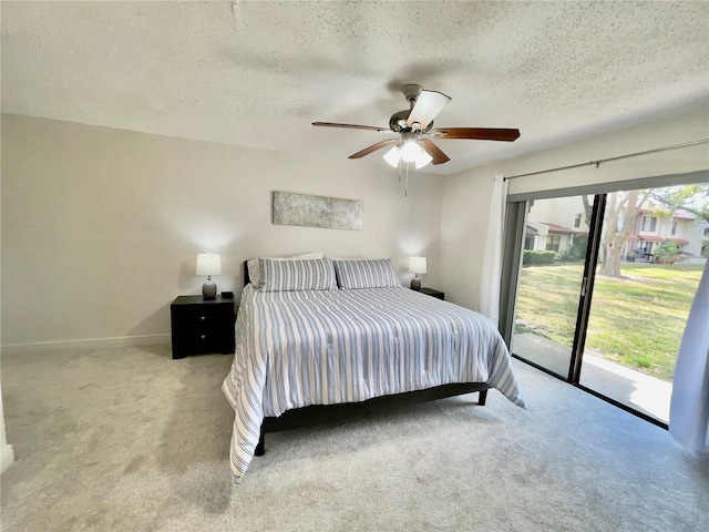 carpeted bedroom featuring ceiling fan, access to outside, and a textured ceiling