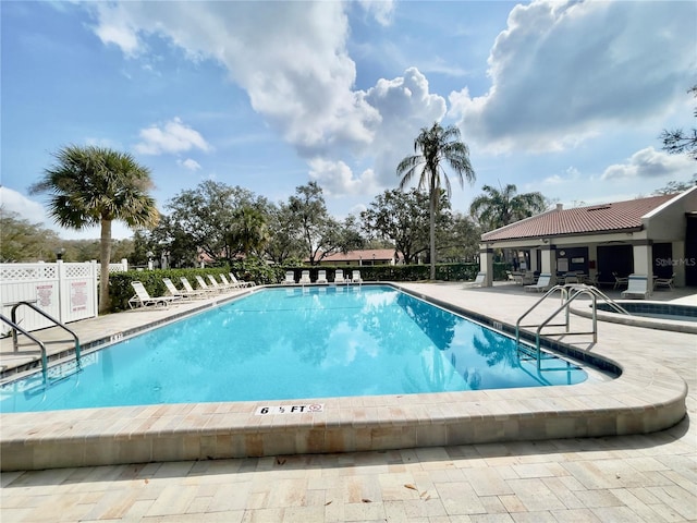 view of swimming pool with a patio