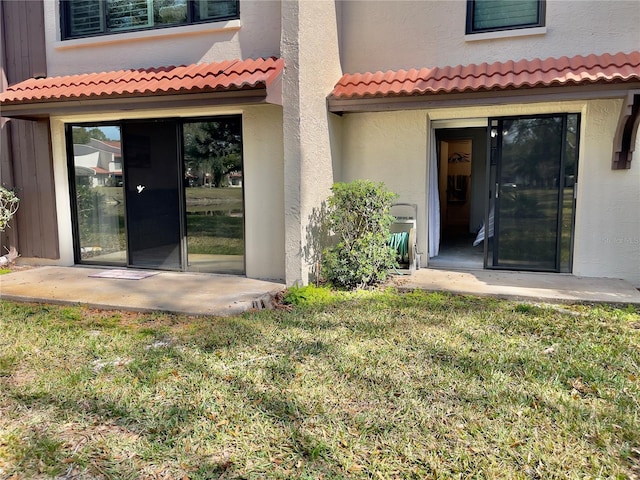 back of house with a yard and a patio