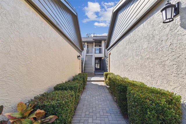 entrance to property featuring stucco siding