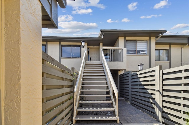 entrance to property featuring stucco siding